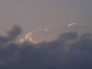 Sun lights up light clouds, leaving others dark